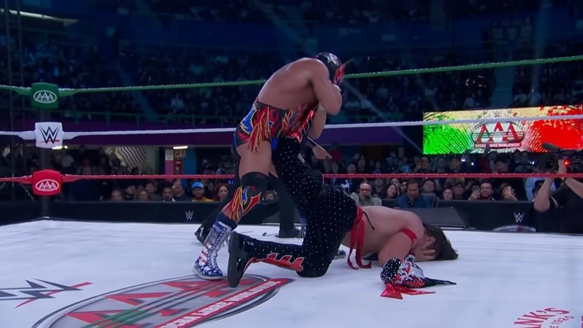 El Grande Americano with an unmasked Octagon Jr. in an ankle lock