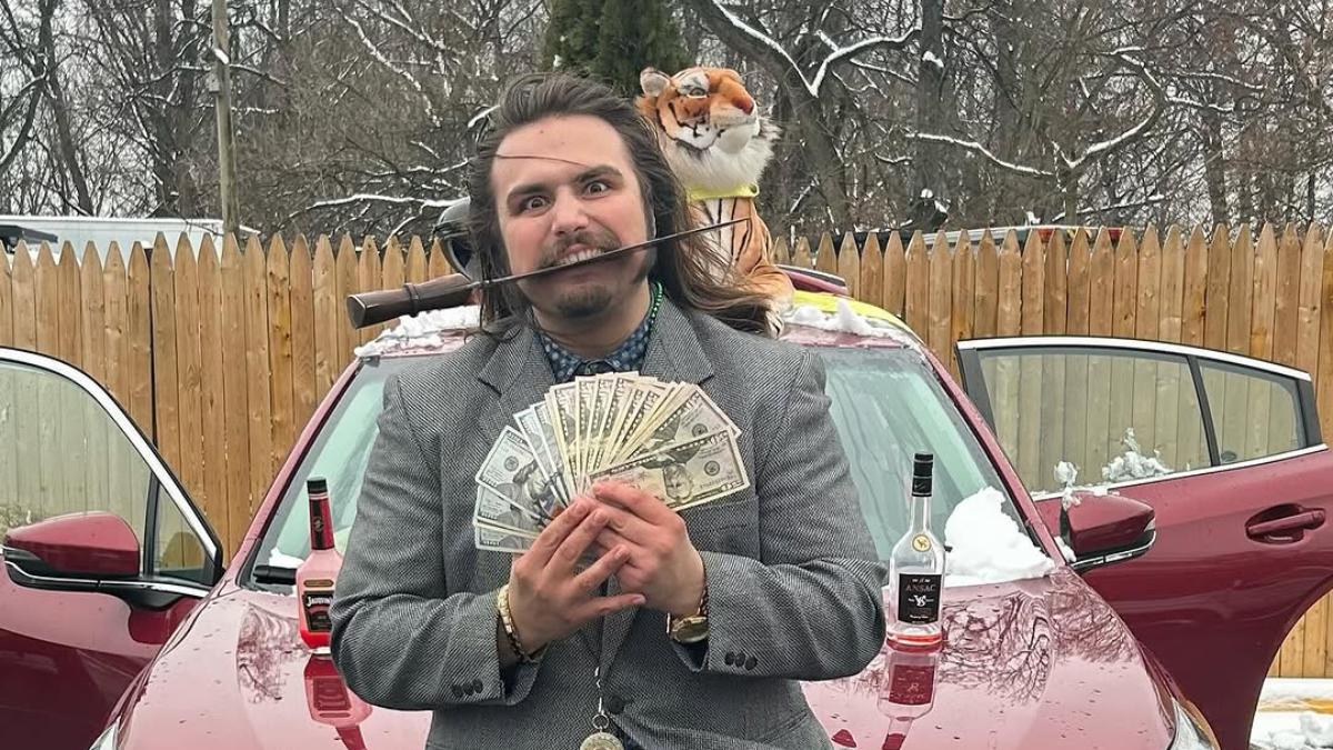 Charlie Tiger in a suit holding a pile of money