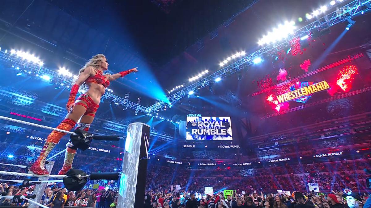 Charlotte Flair pointing at WWE WrestleMania 41 sign