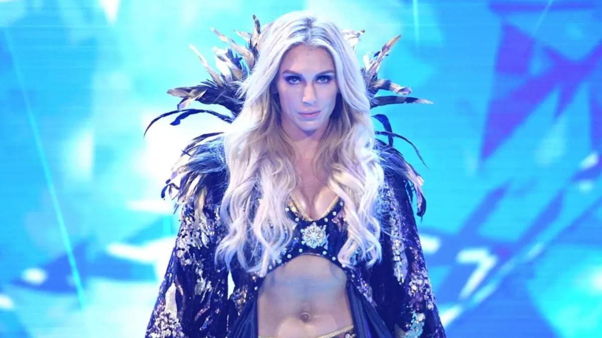 Charlotte Flair in a robe walking down the ramp 