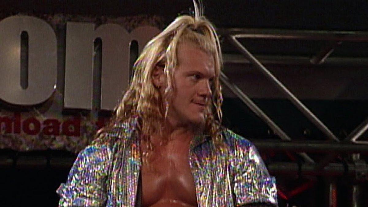 Chris Jericho wearing a silver shirt with his hair in a top knot during his WWE debut in 1999