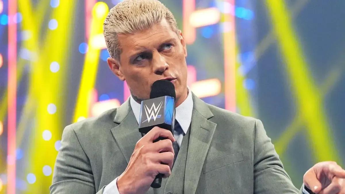 Cody Rhodes in a green suit with a microphone