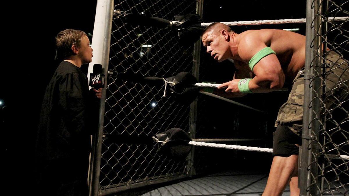 A creepy child singing to John Cena outside of a steel cage at WWE Extreme Rules 2014