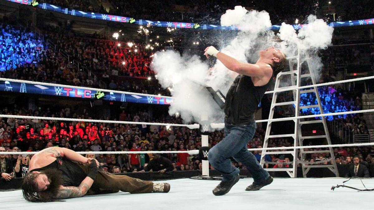 Dean Ambrose falling to the mat surrounded by an explosion at WWE TLC 2014