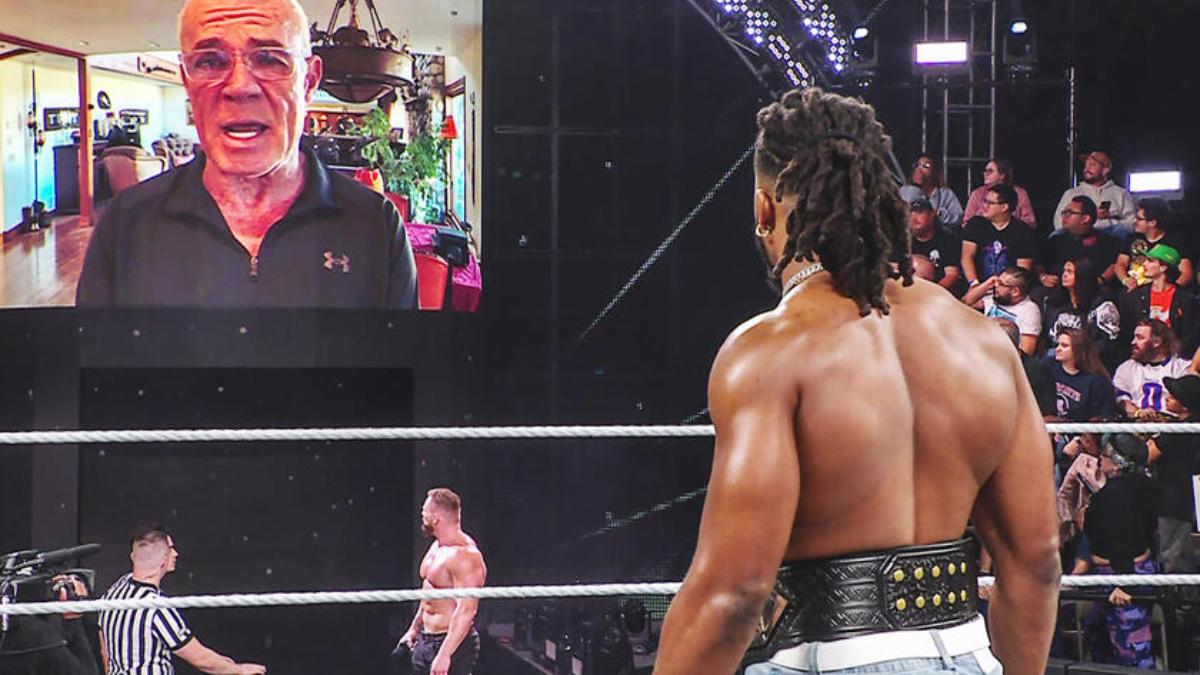 Eric Bischoff on the video screen at WWE NXT with Ridge Holland and Trick Williams in the arena 