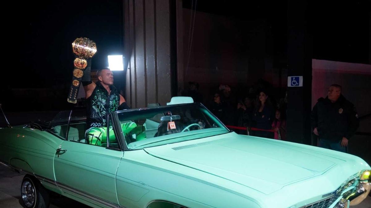 Frankie Kazarian holding up the TNA World Title while sitting on a low rider