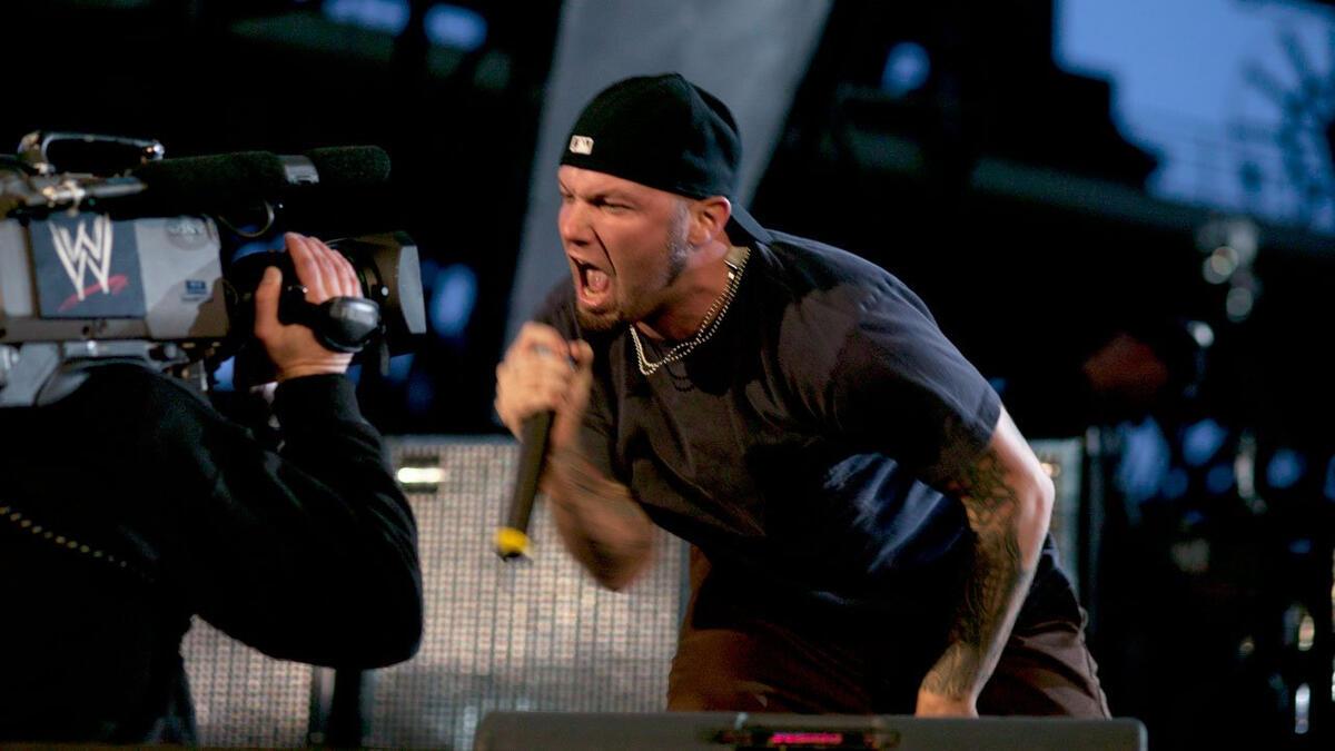 Fred Durst of Limp Bizkit looks into the camera while singing into the microphone at WrestleMania XIX