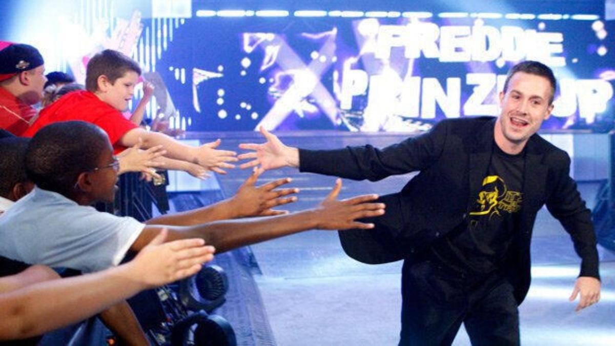 Actor Freddie Prinze Jr. slaps hands with fans as he makes his entrance during an episode of WWE Raw in 2009