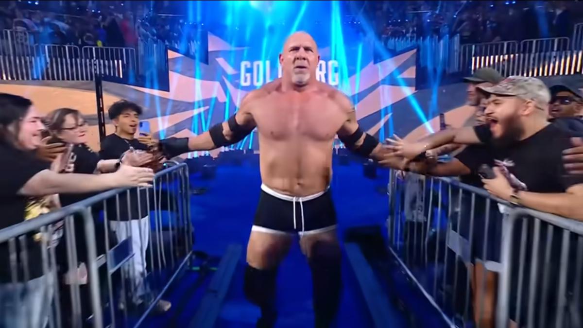 Goldberg slaps hands with fans as he walks to the ring at WWE Saturday Night's Main Event