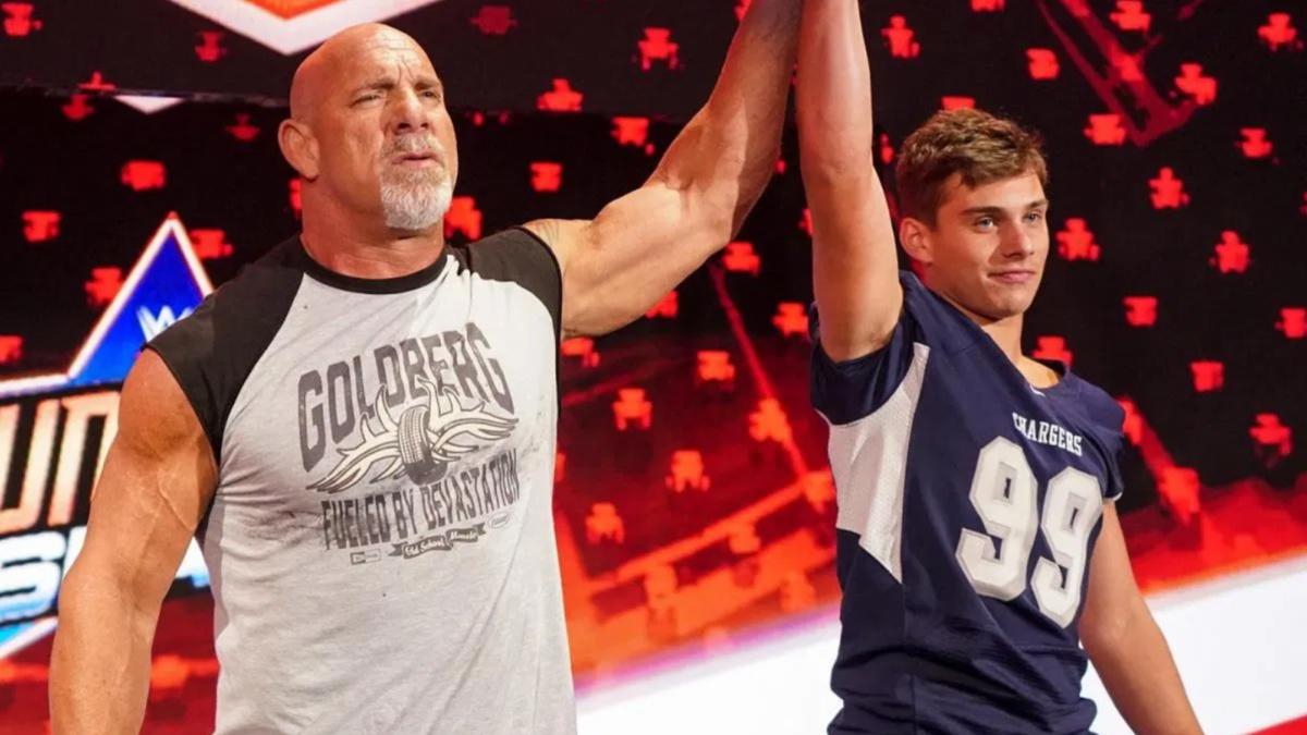 Goldberg raising the hand of his son on the stage 