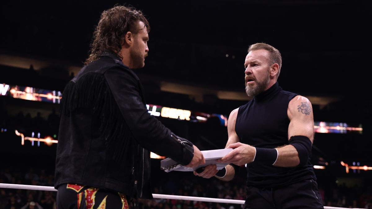 Hangman Page handing Christian Cage his Casino Gauntlet contract at AEW Full Gear 2024