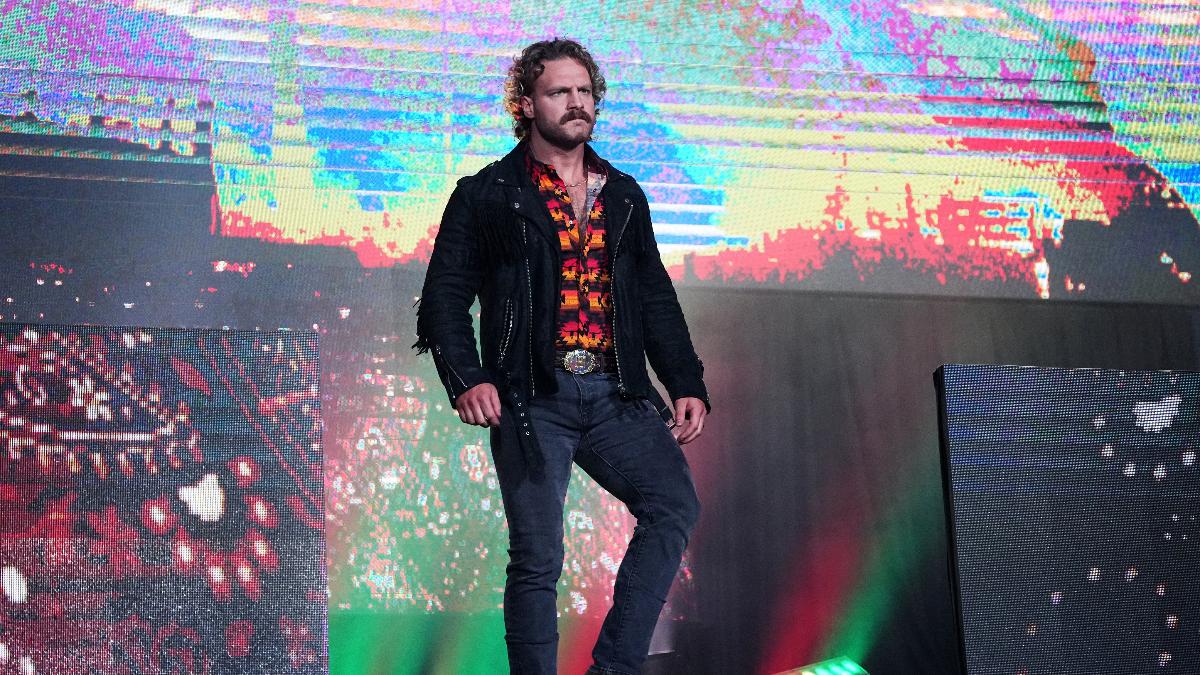 Hangman Page in jeans, shirt, and a jacket, walks down the entrance steps in Arena Mexico