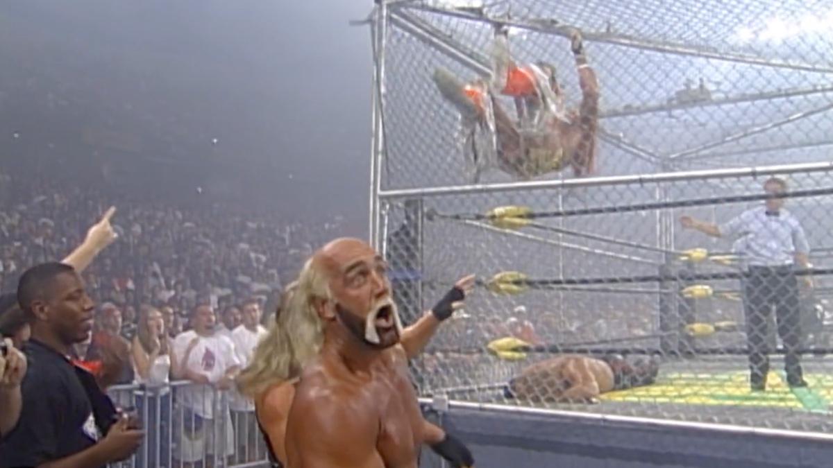 Hulk Hogan looking scared as The Ultimate Warrior kicks his way through the cage 