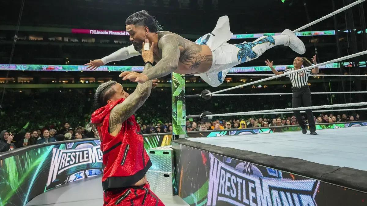 Jey Uso dives out of the ring onto his brother Jimmy during their match at WrestleMania 40