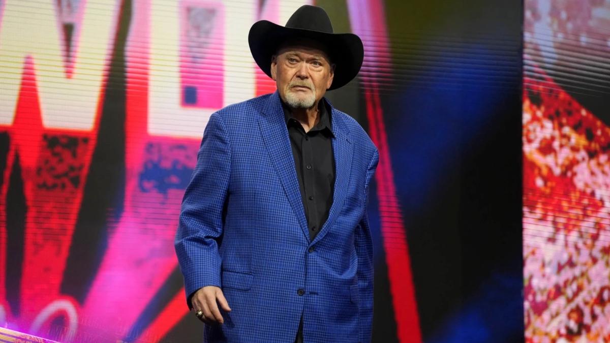 Jim Ross wearing a blue suit and cowboy hat