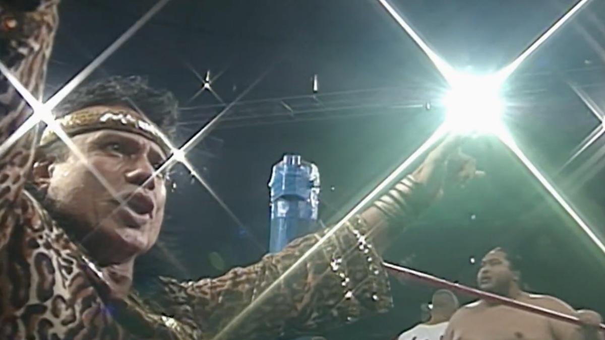 Jimmy Snuka on the steel steps throwing up his signature post at Survivor Series 1996