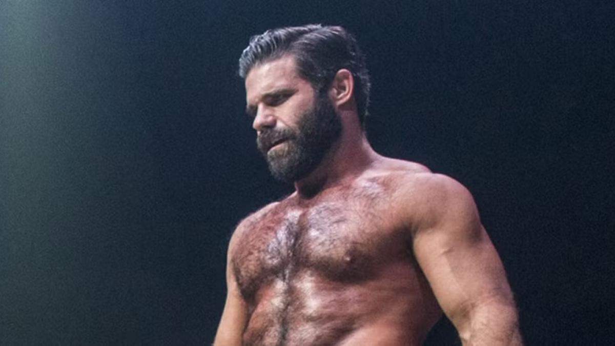 A shirtless Joey Ryan staring off camera