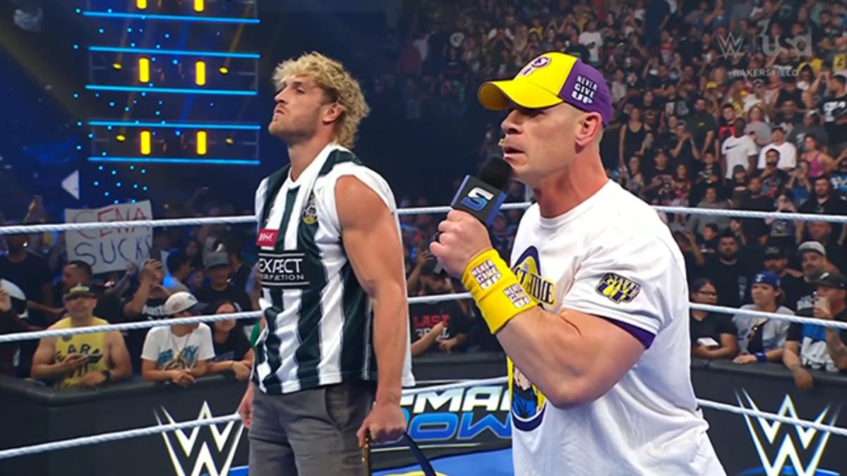 John Cena talking into a mic next to Logan Paul 