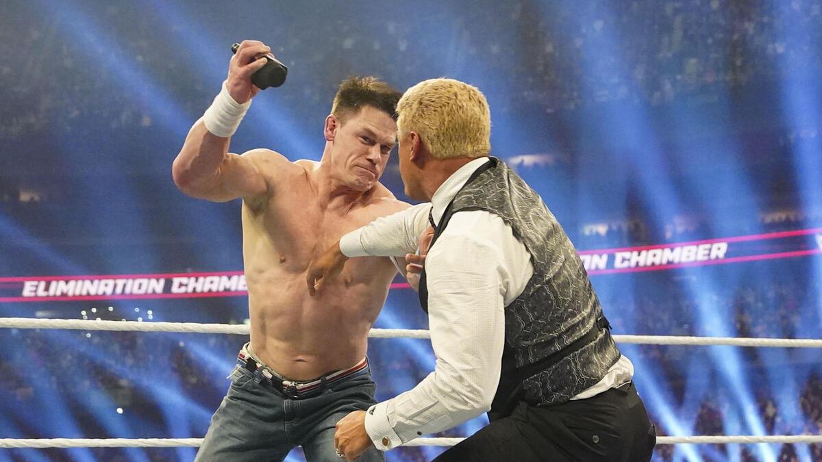 John Cena hitting Cody Rhodes with a microphone at WWE Elimination Chamber 2025