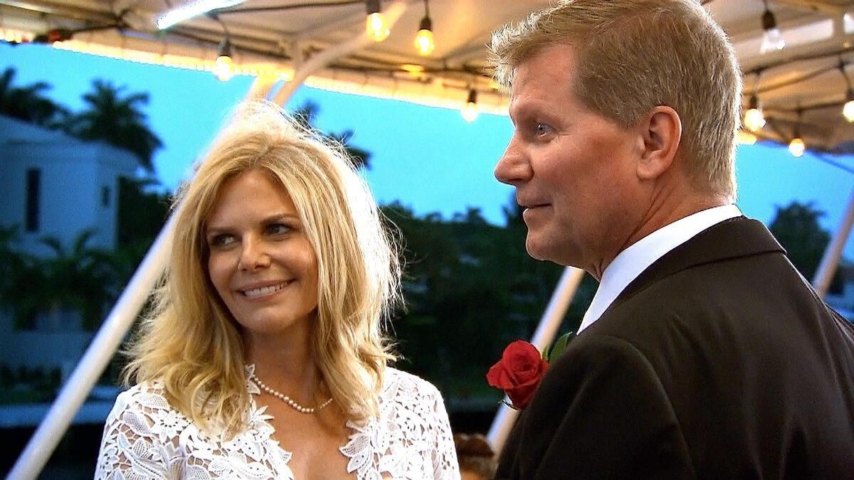 Kathy Colace in a wedding dress with John Laurinaitis in a suit on their wedding day