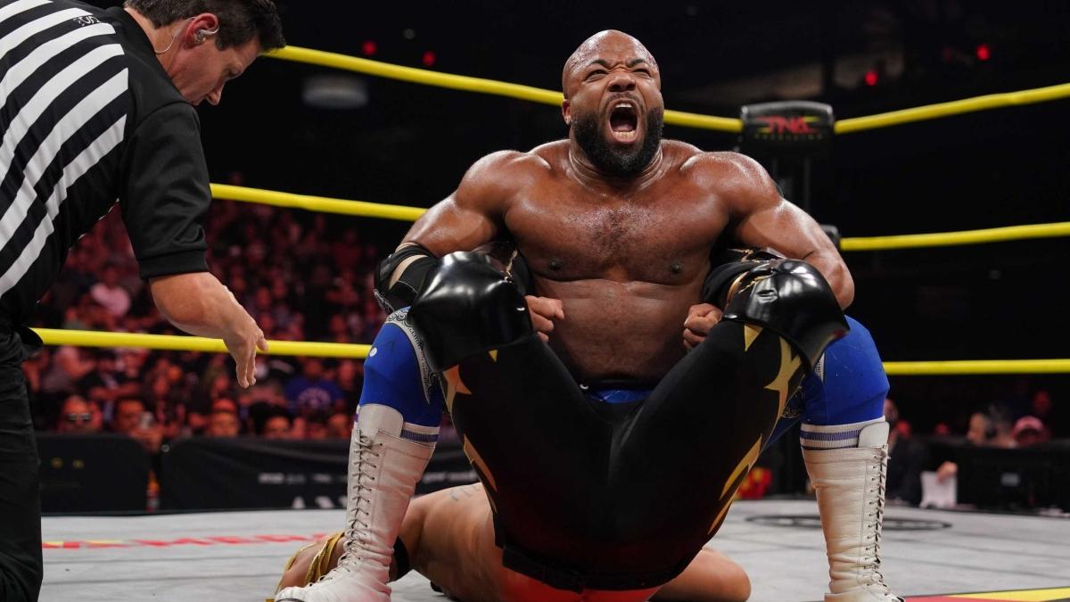 TNA star Jonathan Gresham applies a Boston Crab submission hold on Laredo Kid during a match in 2024.