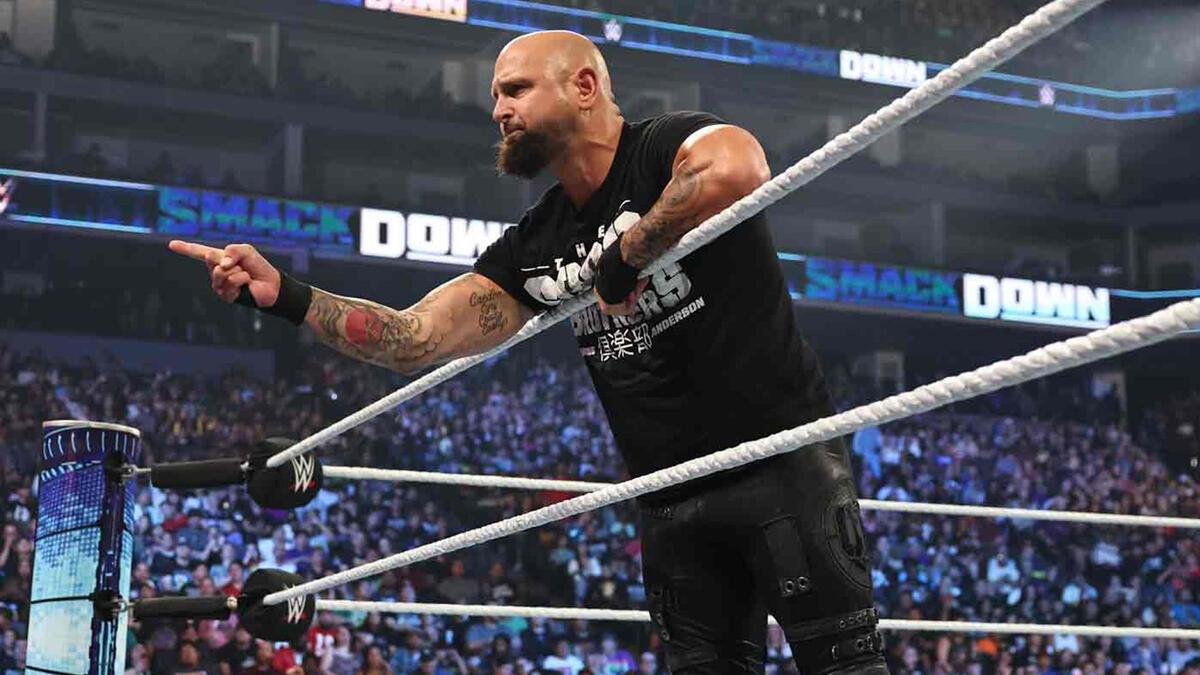 WWE star Karl Anderson stands in the ring pointing during an episode of SmackDown