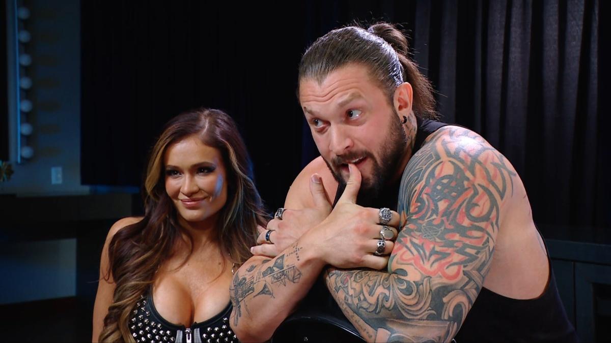 Karrion Kross with thumb in mouth with Scarlett