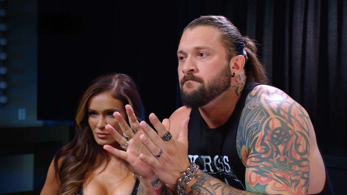 Karrion Kross looking unamused sitting with Scarlett