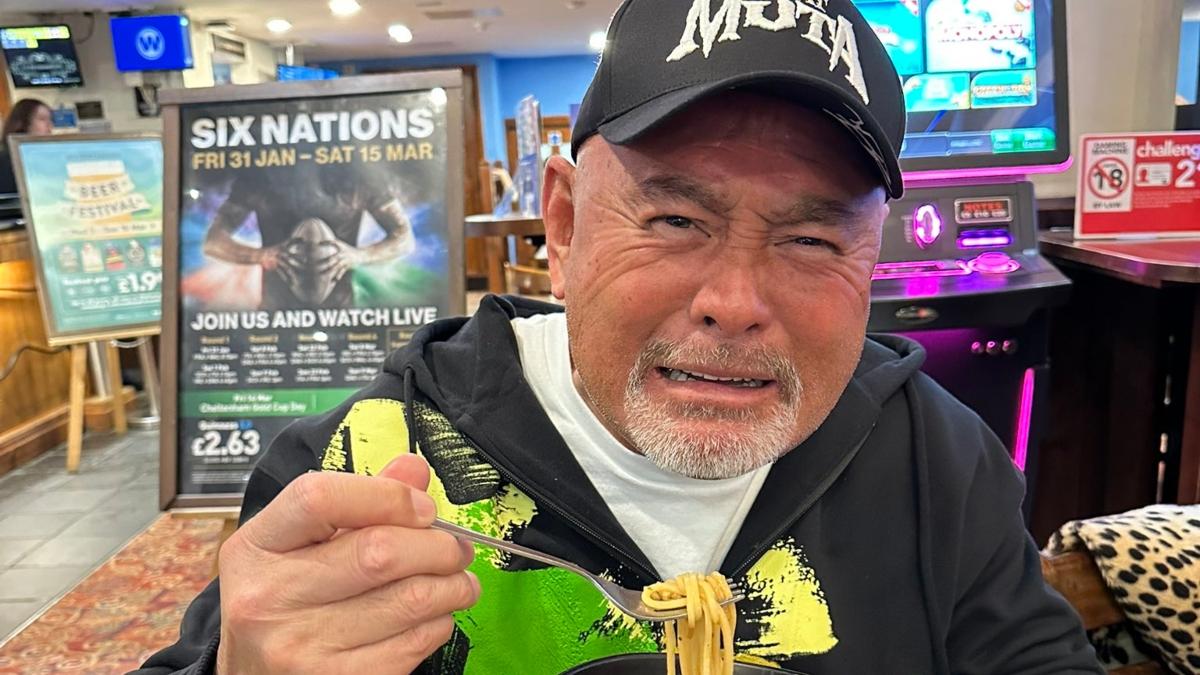 Professional wrestling legends shows his disgust while sampling ramen from UK pub chain Whetherspoons