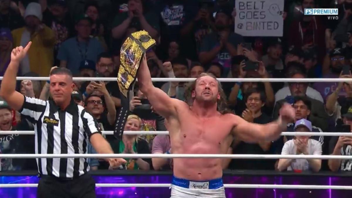 Kenny Omega holds up the AEW International Championship in an AEW ring