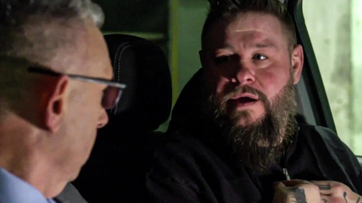 Kevin Owens staring at Michael Cole while sitting in his car on a December 2024 episode of SmackDown