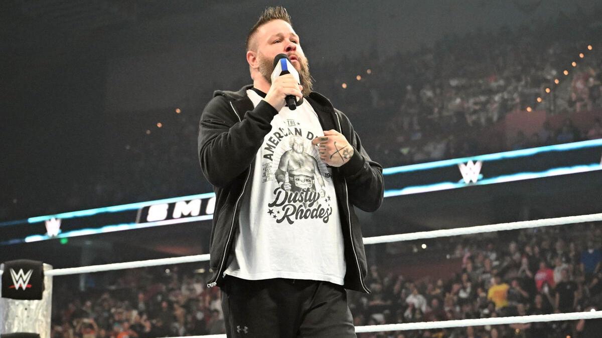 Kevin Owens in a Dusty Rhodes t-shirt in a WWE SmackDown ring