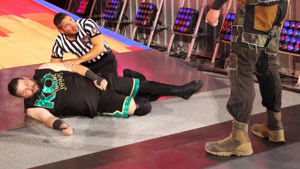 Kevin Owens in pain after a Chokeslam on the stage at SummerSlam 2018