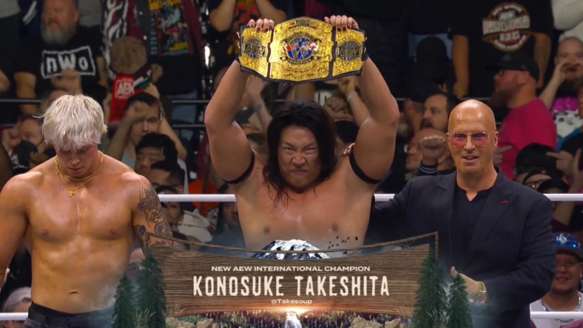 Konosuke Takeshita celebrating his AEW International Title win with Don Callis and Kyle Fletcher at WrestleDream