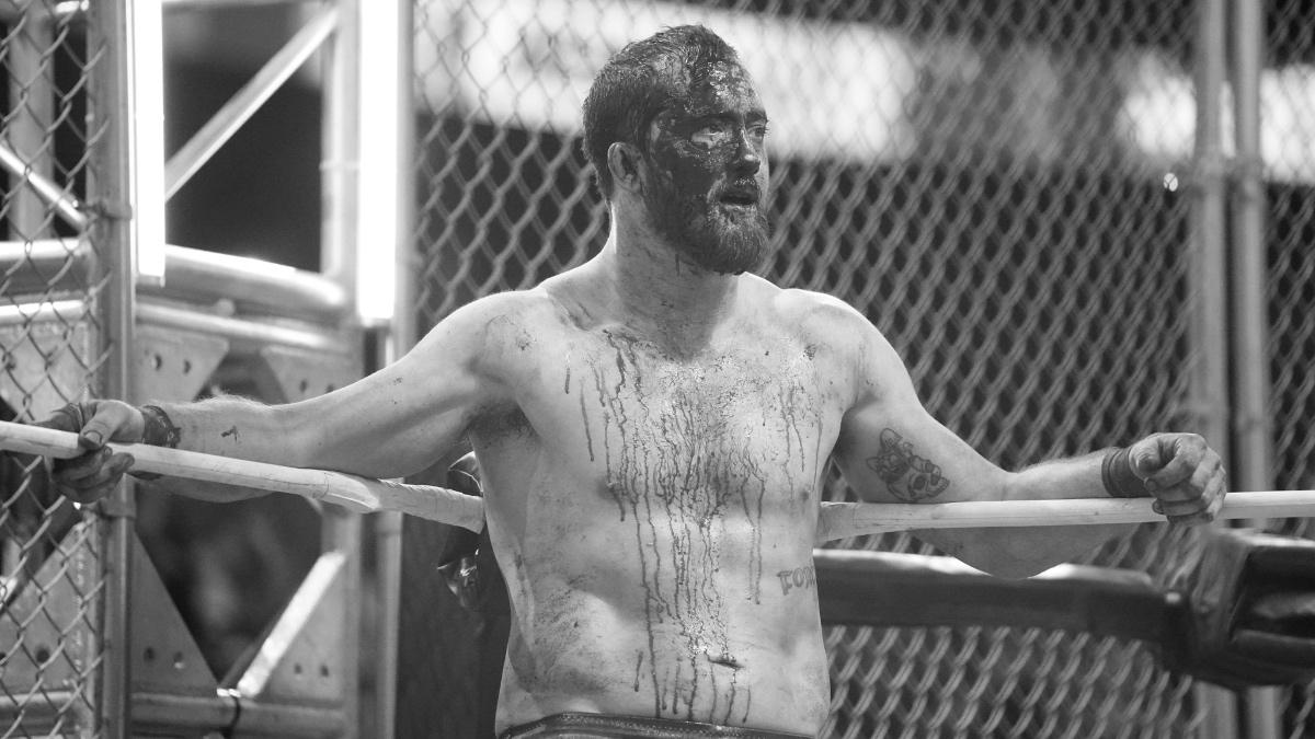 Kyle O'Reilly covered in blood at AEW Blood & Guts in a black and white image