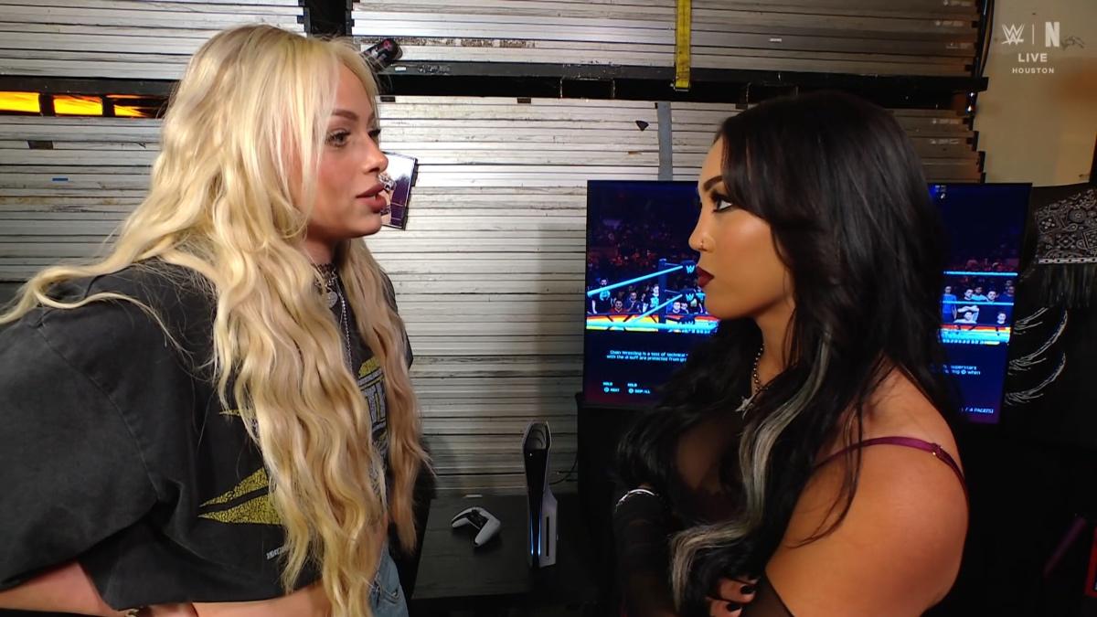 Roxanne Perez on the right and Liv Morgan on the left staring at each other backstage on WWE Raw