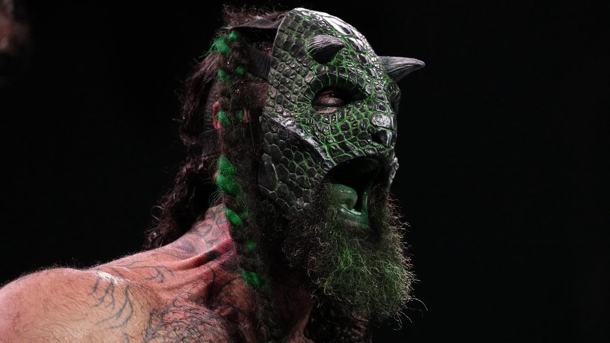Luchasaurus wearing a green scaled mask shouting