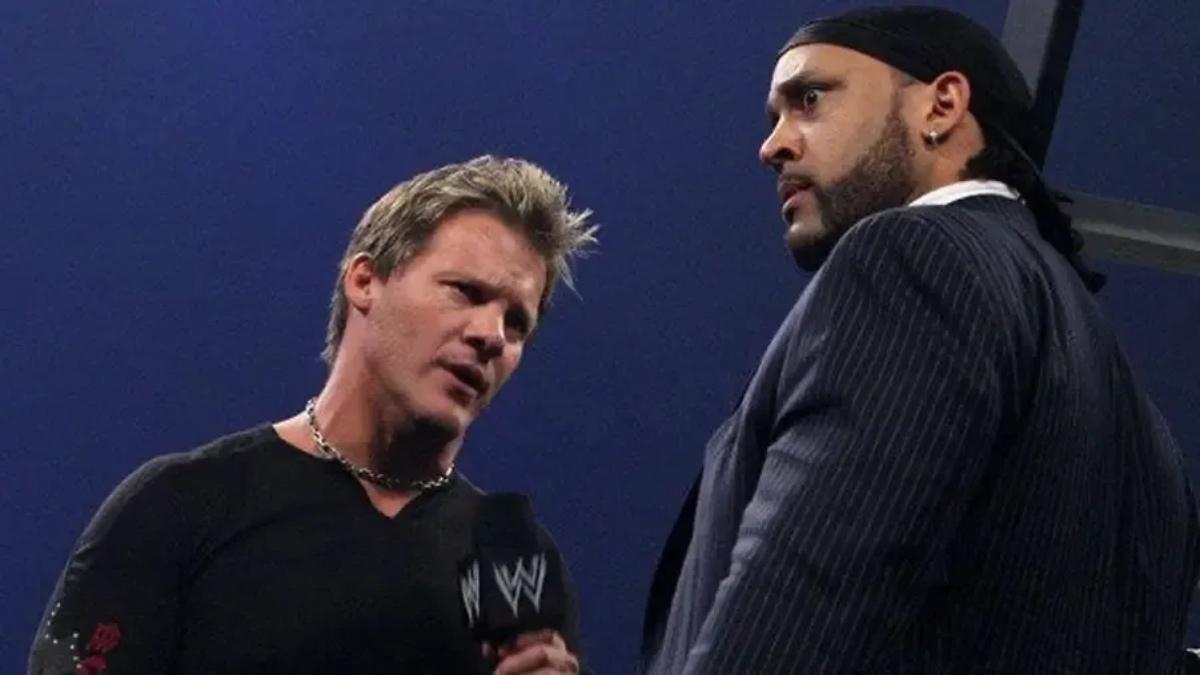 Chris Jericho looking at MVP while MVP looks shocked inside a WWE ring 