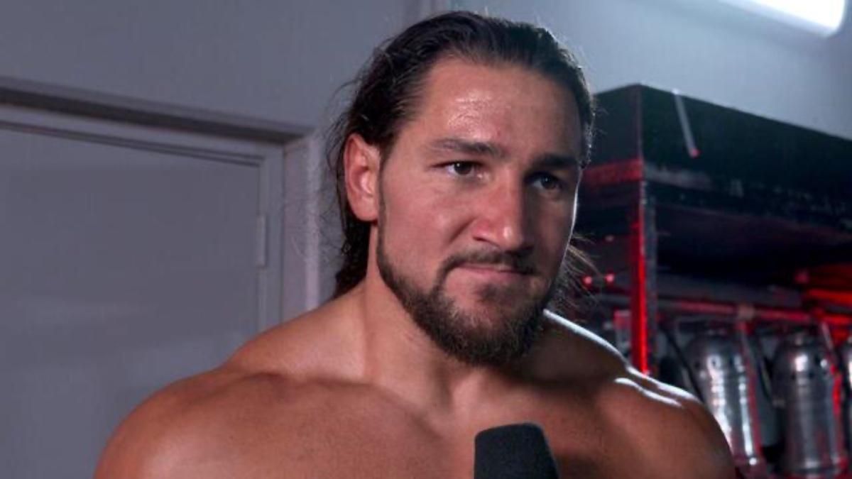 Madcap Moss looking side while being interviewed backstage at a WWE event