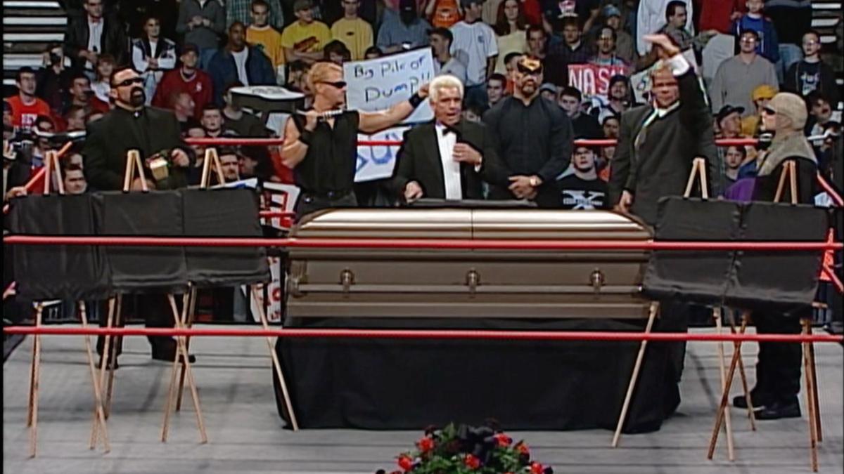 Magnificent Seven standing next to a coffin in WCW