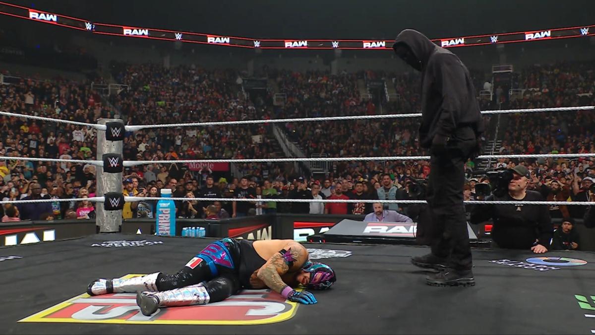 Masked Man standing over Rey Mysterio on December 2025 episode of WWE Raw