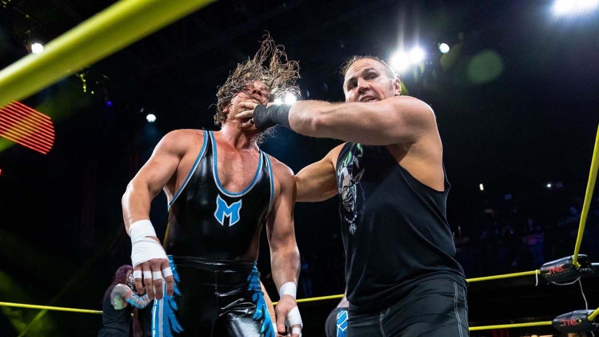 Matt Hardy grabbing Brian Myers face as he leads him to the turnbuckle on TNA IMPACT
