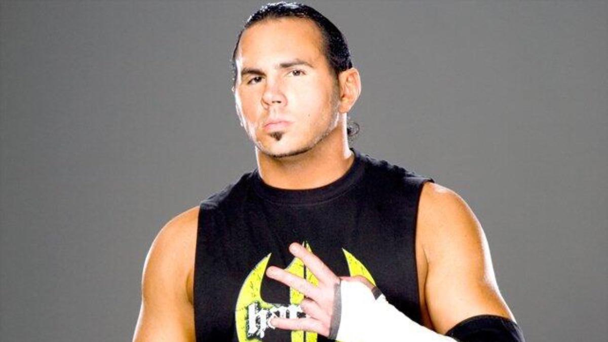 Matt Hardy standing for a WWE photoshoot with his hand up