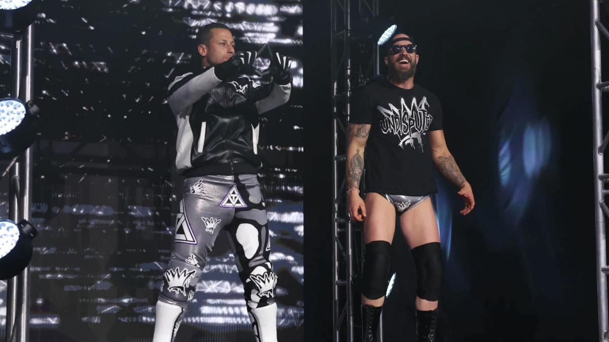 Matt Taven in a jacket and Mike Bennett in a t-shirt cap and sunglasses posing on a ROH entrance stage