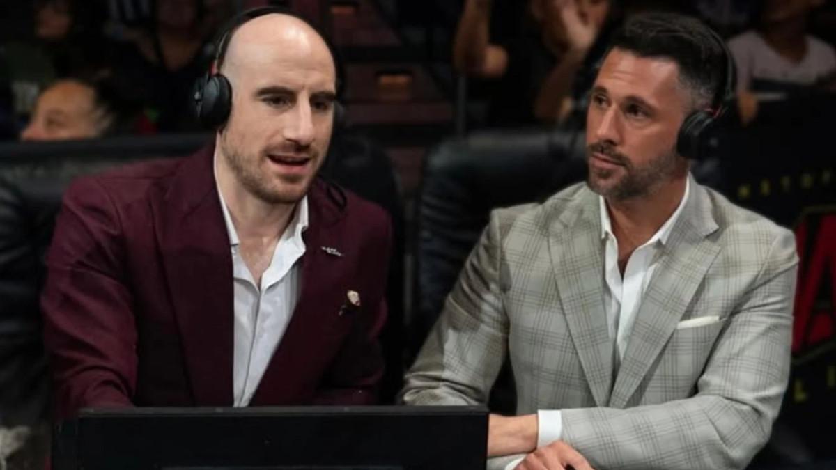 Matthew Rehwoldt and Tom Hannifan in headsets sat behind a desk