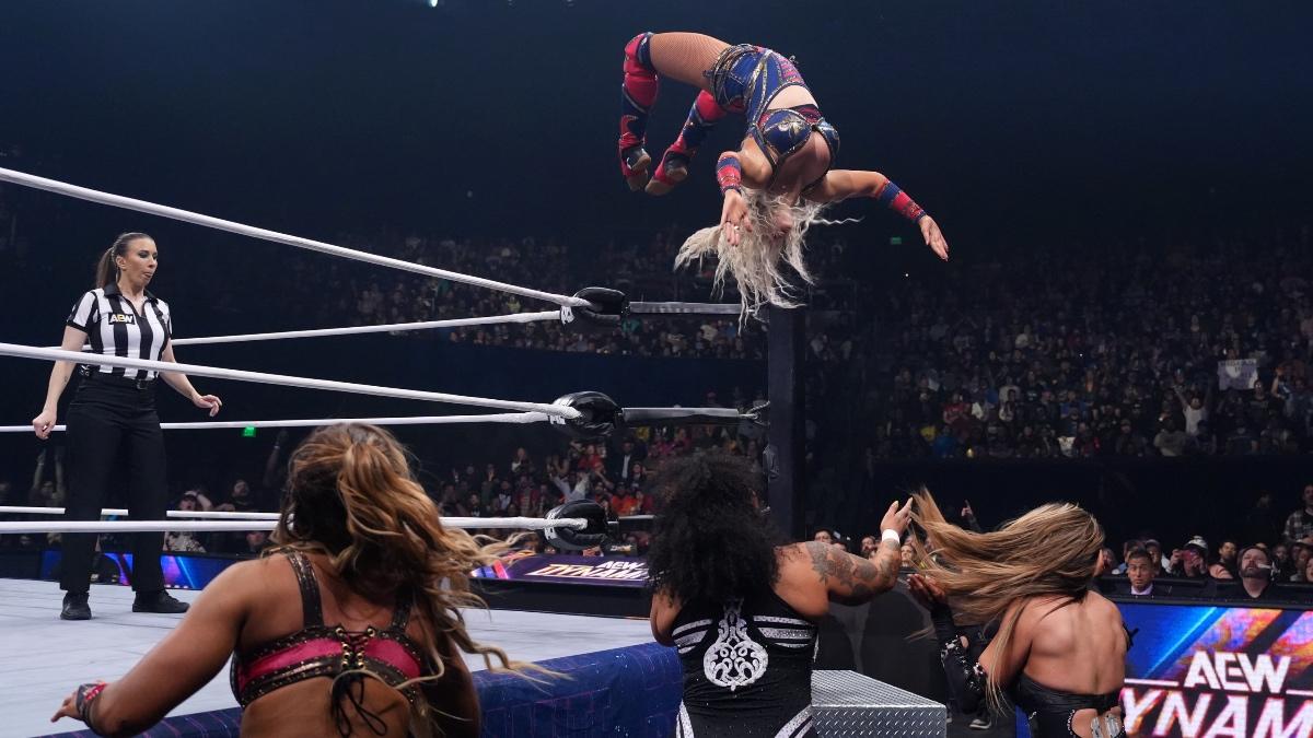 Penelope Ford hitting a Moonsault to Willow Nightingale and Harley Cameron as Megan Bayne stands to the side 