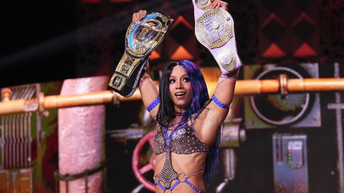 Mercedes Mone holding up two titles at AEW Full Gear 