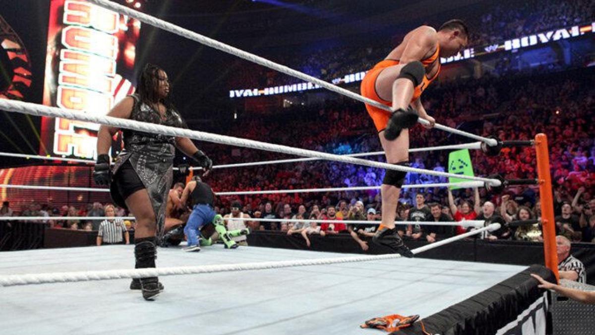 Michael Cole climbing over the top rope at WWE Royal Rumble 2012