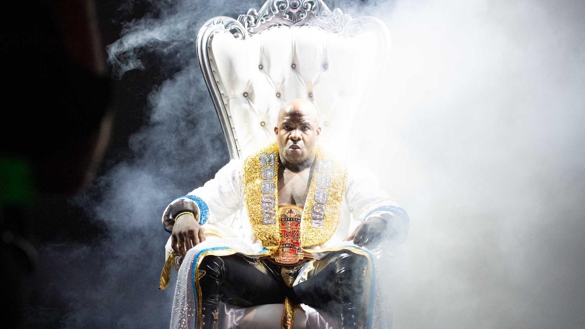 Moose sitting on a white throne as smoke drifts in from the right hand side