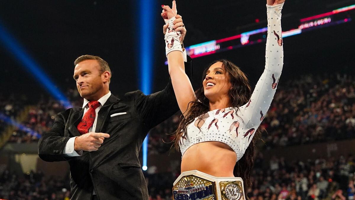 Nick Aldis raises Chelsea Green's hand after her WWE Women's United States Title victory at Saturday Night's Main Event